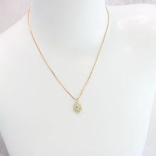 18K gold plated Hamsa Evil Eye necklace on mannequin. 