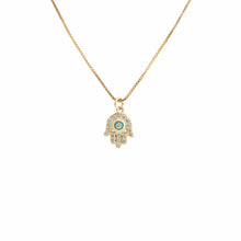 An 18K gold plated hamsa hand pendant with 1mm box chain on a white background. 