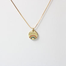 An 18K gold plated rainbow burst necklace with multicolored cubic zirconia rhinestones, on a box chain with a lobster clasp.