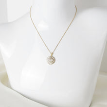 Gold stainless steel Evil Eye rhinestone pendant necklace with sparkling crystal accents on a mannequin. 