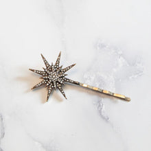 Rhinestone gold star hairpin on marble background