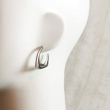 Contoured silver drop earrings stainless steel on mannequin. 