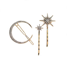 Gold-tone moon and star rhinestone hair pin set featuring one crescent moon hair clip and two sparkling star bobby pins on a white background.