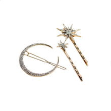 Gold-tone moon and star rhinestone hair pin set featuring one crescent moon hair clip and two sparkling star bobby pins on a white background.