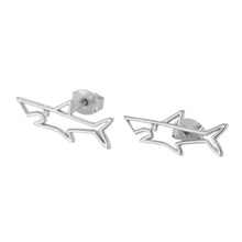 Pair of silver colored shark stud earrings on white background.