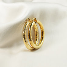 18K gold plated 50mm faceted hoop earrings with a textured grid pattern on a white background