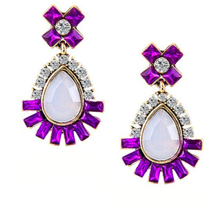 Elegant purple rhinestone earrings with a white iridescent water drop stone and clear crystals. Earrings measure 1 1/2" long by 1" wide.