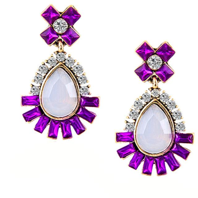 Elegant purple rhinestone earrings with a white iridescent water drop stone and clear crystals. Earrings measure 1 1/2