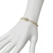 Gold double beaded chain bracelet with oval rhinestone center charm on mannequin.