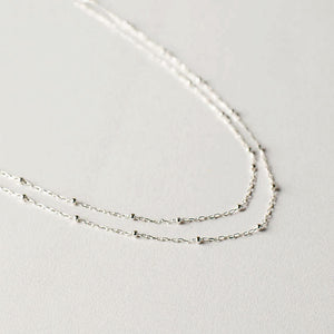 Long silver tone beaded chain necklace can be worn three different ways so you get three different looks for the price of one! Necklace measures 52" with a 2" extension. 