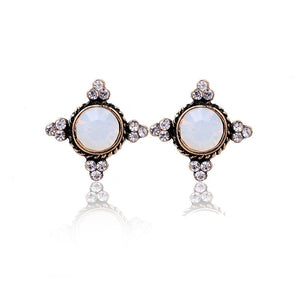 Vintage style white opalescent earrings with crystal accents in goldtone. Earrings measure 3/4" wide by 3/4" long.
