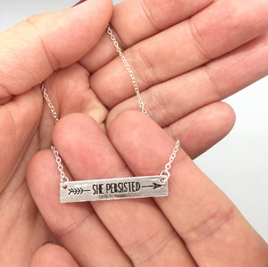 "She Persisted" Engraved Necklace - Left Arrow