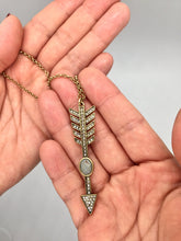 Glam crystal arrow necklace in an antique gold color chain and faux stone. Necklace measures 20" long. Arrow measures 2 3/8" long by 1/2" wide.
