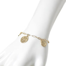 Dainty gold charm paperclip chain bracelet with cross bracelet on mannequin