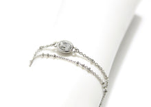 Silver double beaded chain bracelet with oval rhinestone center charm.