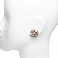 Vintage style gold rhinestone flower stud earrings on mannequin ear.